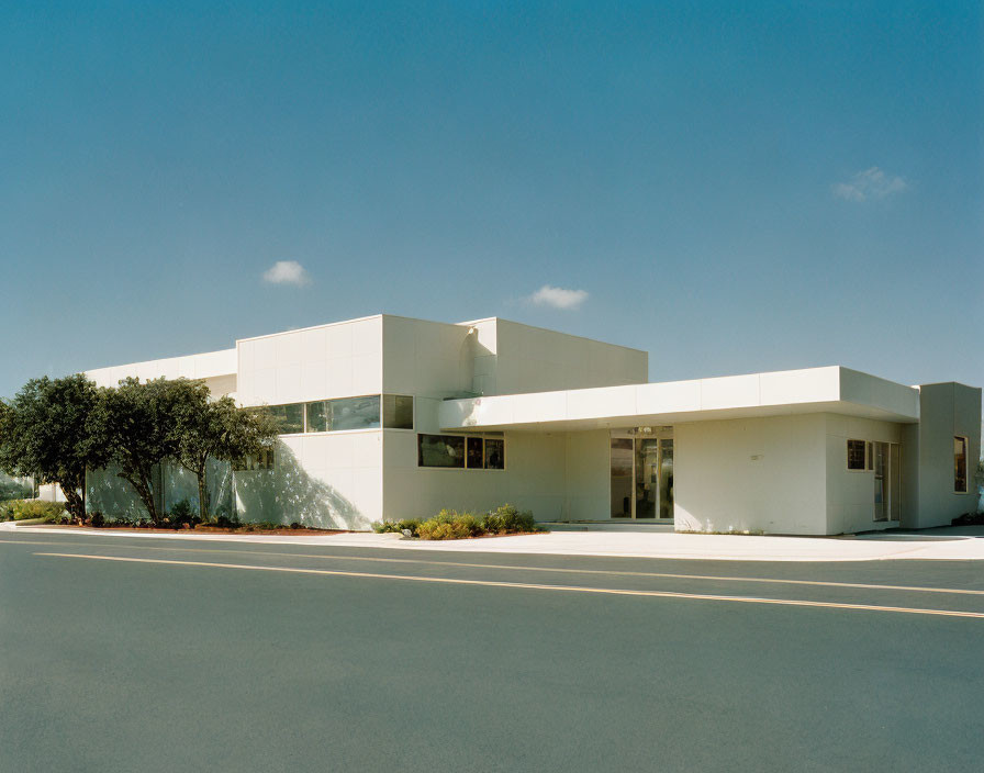 Cubic White Building Against Blue Sky with Street View