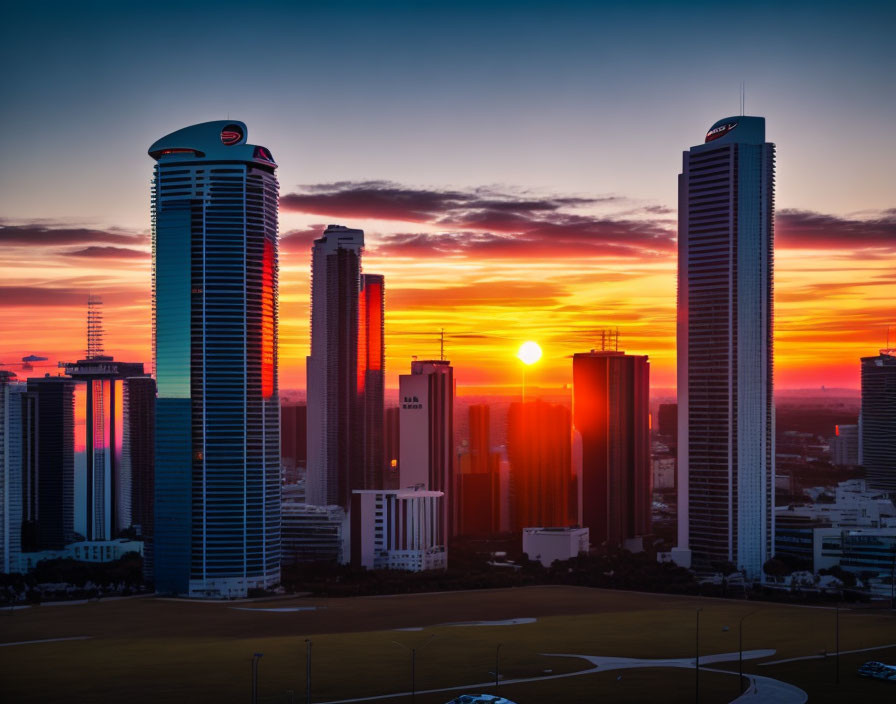 City skyline at sunset with tall skyscrapers under orange glow