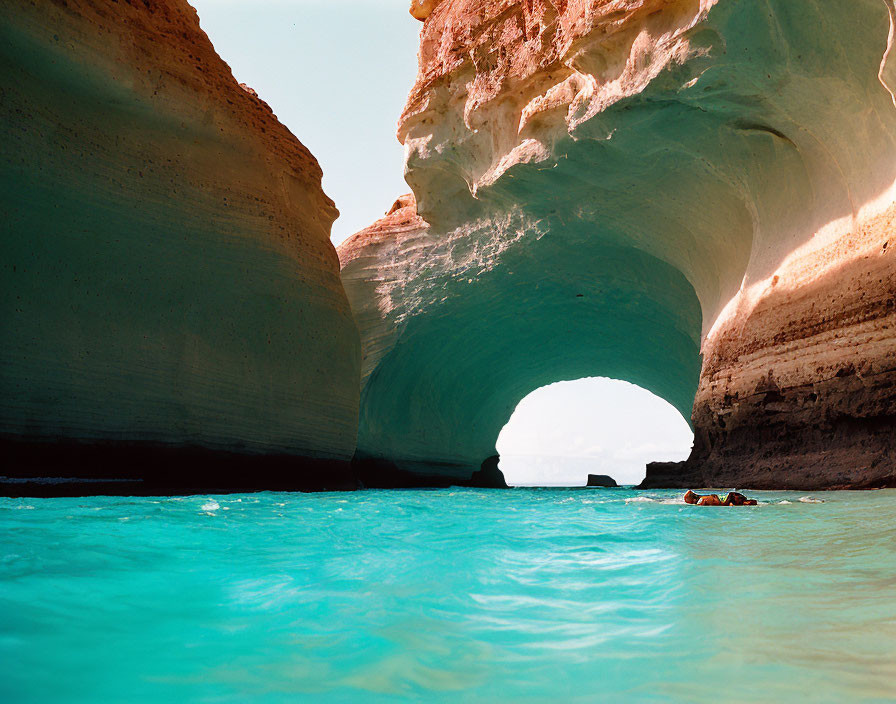 Tranquil Sea Cave with Arch Overlooking Blue Waters