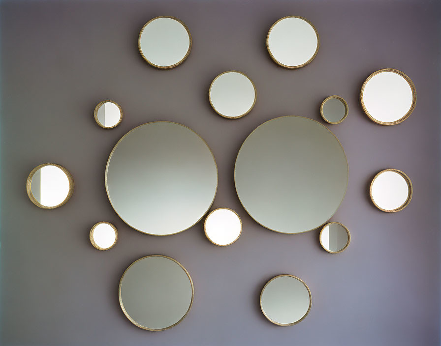 Round Mirrors in Various Sizes on Purple Wall