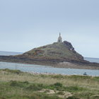 Tranquil landscape: church on rocky island in vibrant sea