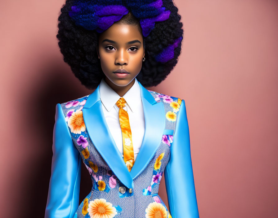 Person with Large Purple Afro in Floral Blue Suit on Pink Background