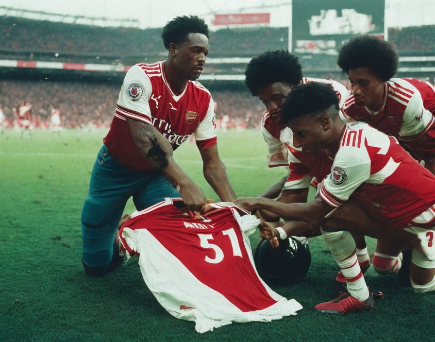 Red and White Soccer Players Supporting Injured Teammate on Pitch