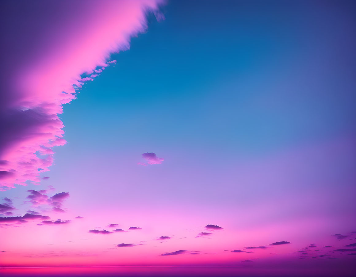 Colorful pink to blue gradient skyscape with fluffy clouds and clear sky.