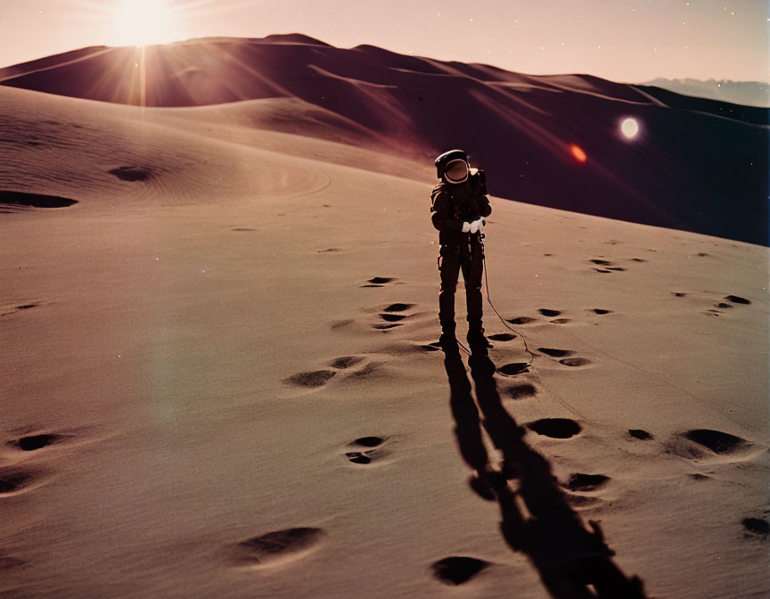 Astronaut on sandy moon-like terrain with dunes and long shadow.