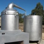 Shiny steampunk-style copper boilers with intricate detailing against clear sky