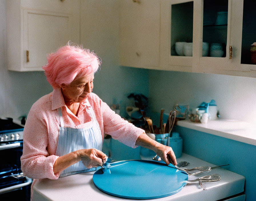 Elderly woman with pink hair cooking in cozy kitchen