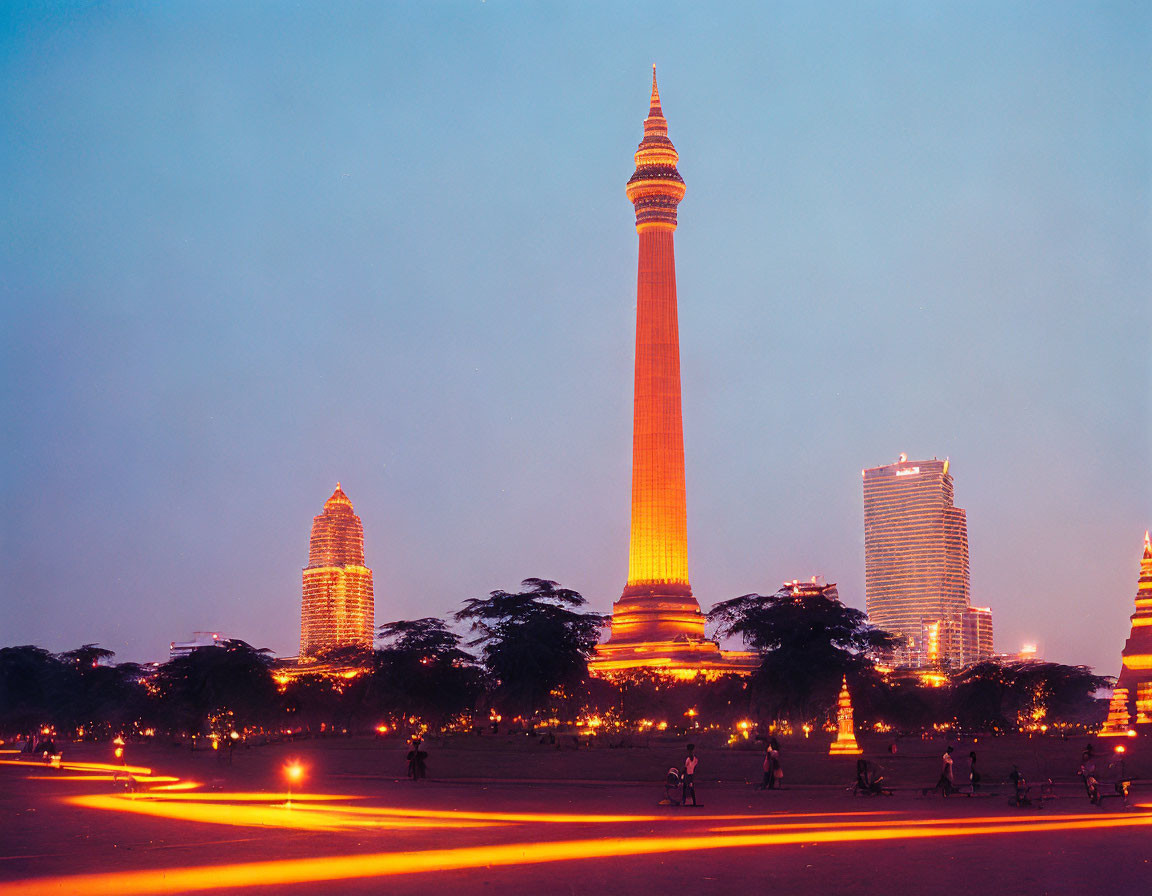 Cityscape at Twilight: Brightly Lit Tower and Silhouettes