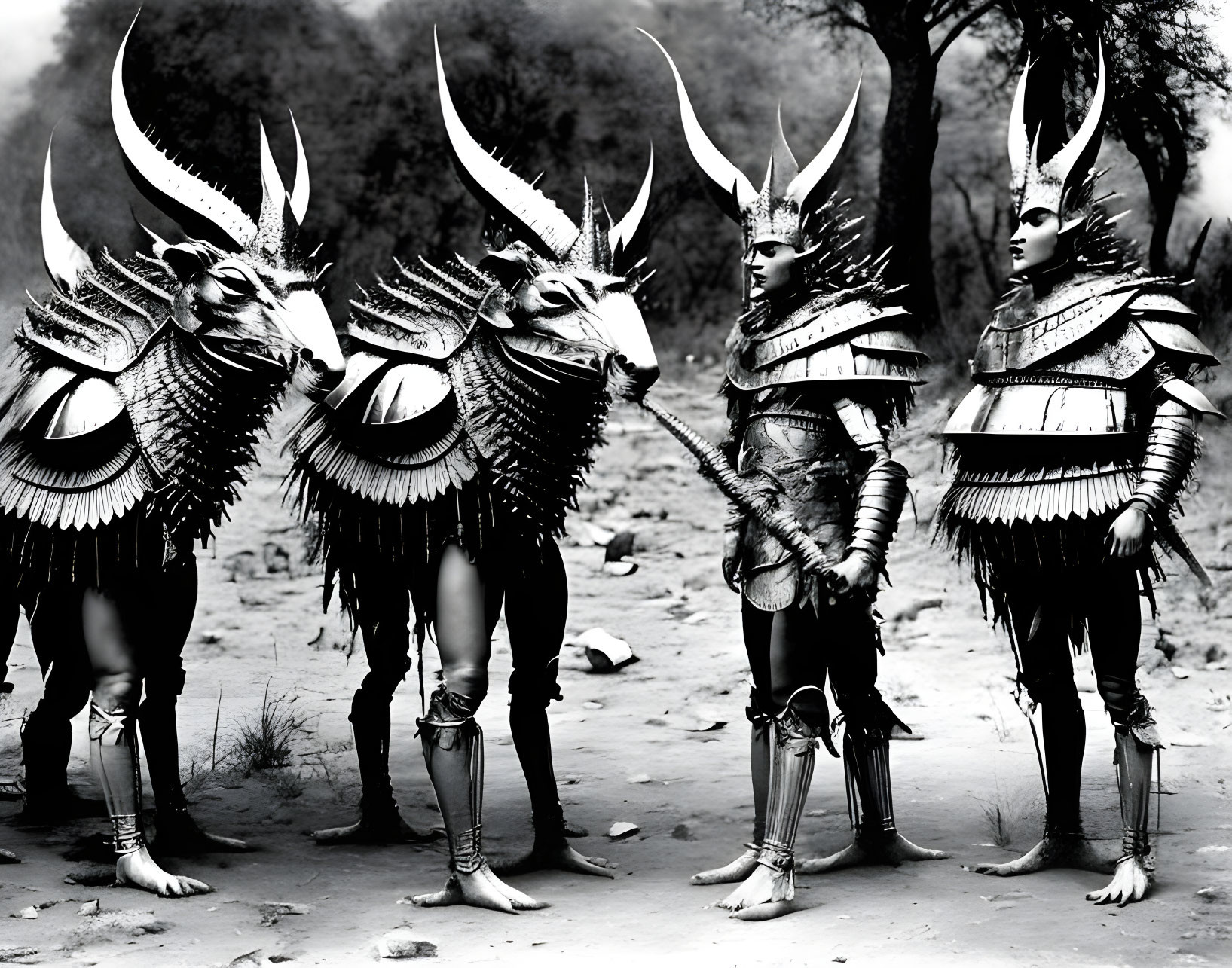 Four individuals in horned headdresses and armor in natural outdoor setting