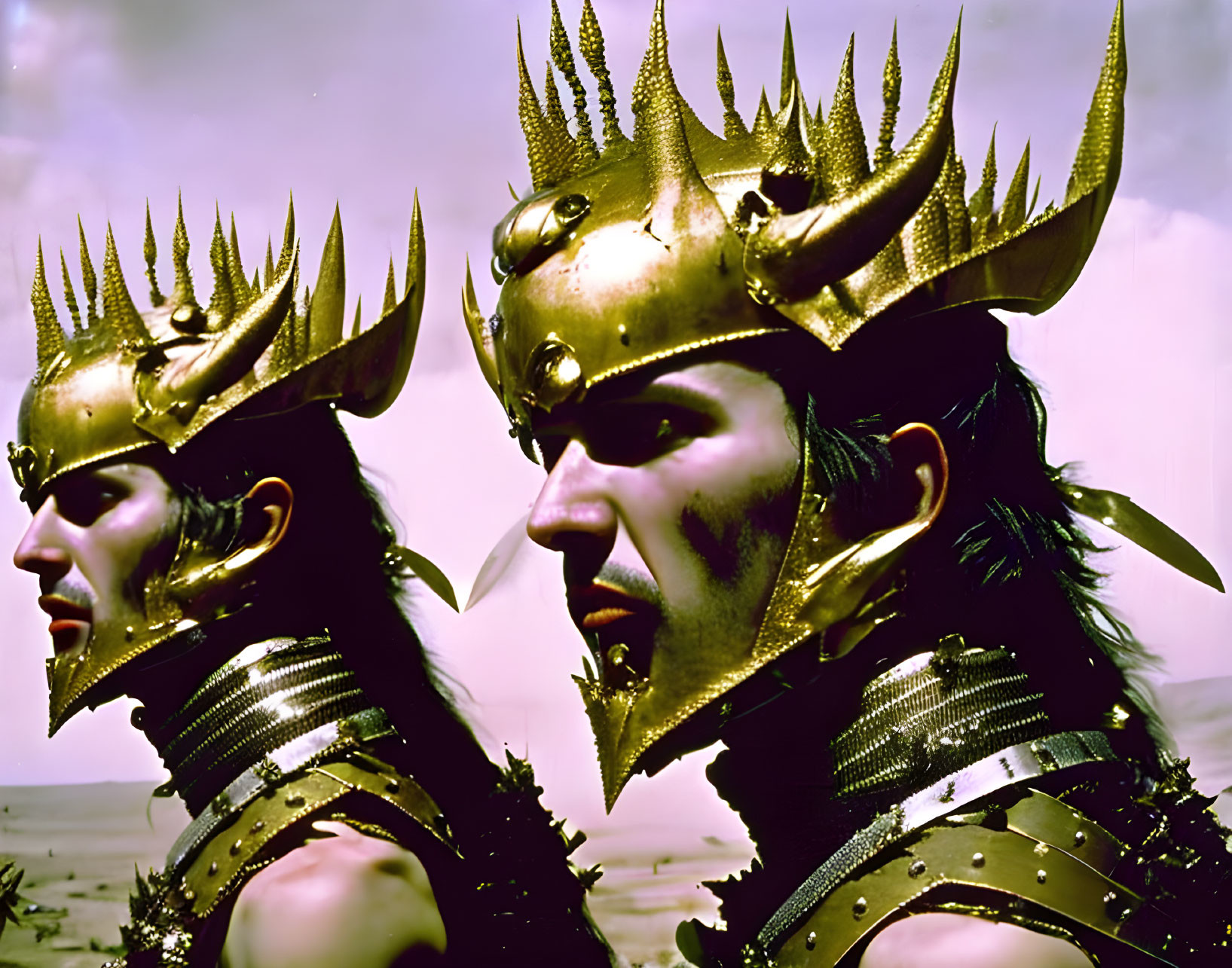 Two individuals in spiked gold crowns and armor against sky backdrop