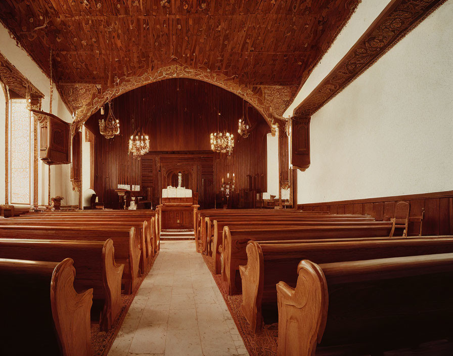 Ornate Wooden Chapel Interior with Pews, Altar, Ceiling, and Chandeliers