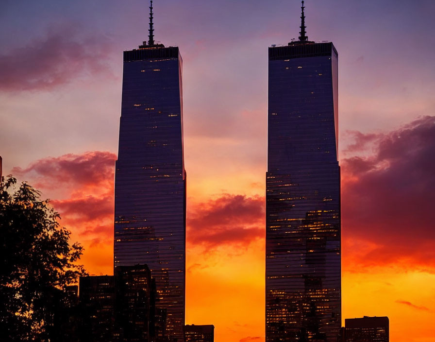 Twin skyscrapers in vibrant sunset reflection