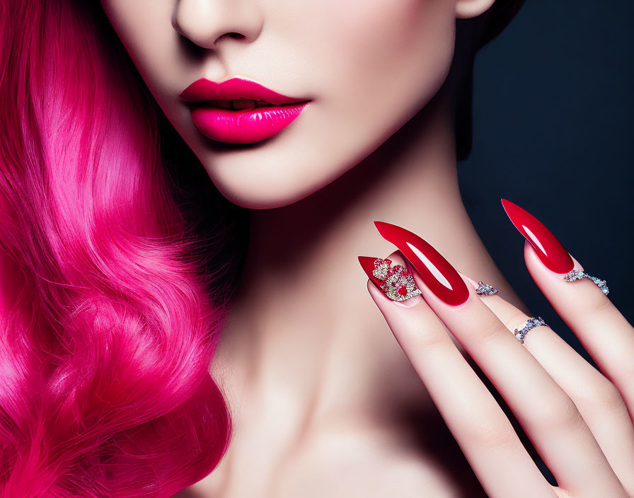 Vibrant pink hair, red lipstick, long nails with statement ring & diamond bands