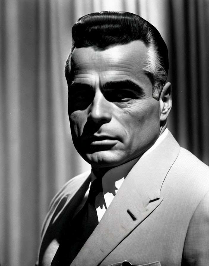 Monochrome portrait of man in suit with slicked-back hair