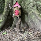 Enchanting fairy tale setting with pink door in old tree