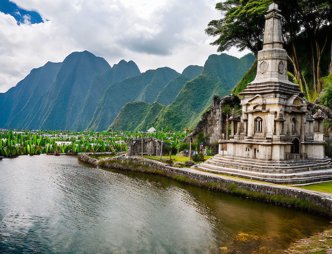 Scenic lake with stone monument, lush greenery, and mountain peaks