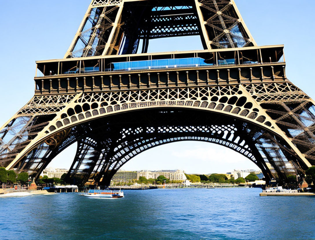 Detailed view of Eiffel Tower base with iron lattice work and boat on Seine river