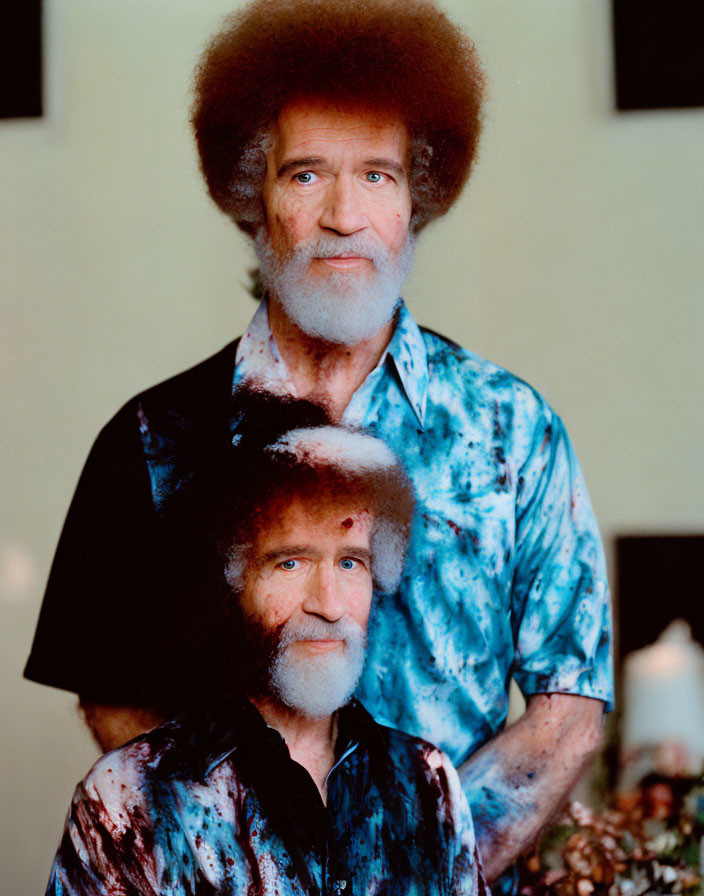 Two men with large afros and patterned shirts in portrait-style photo