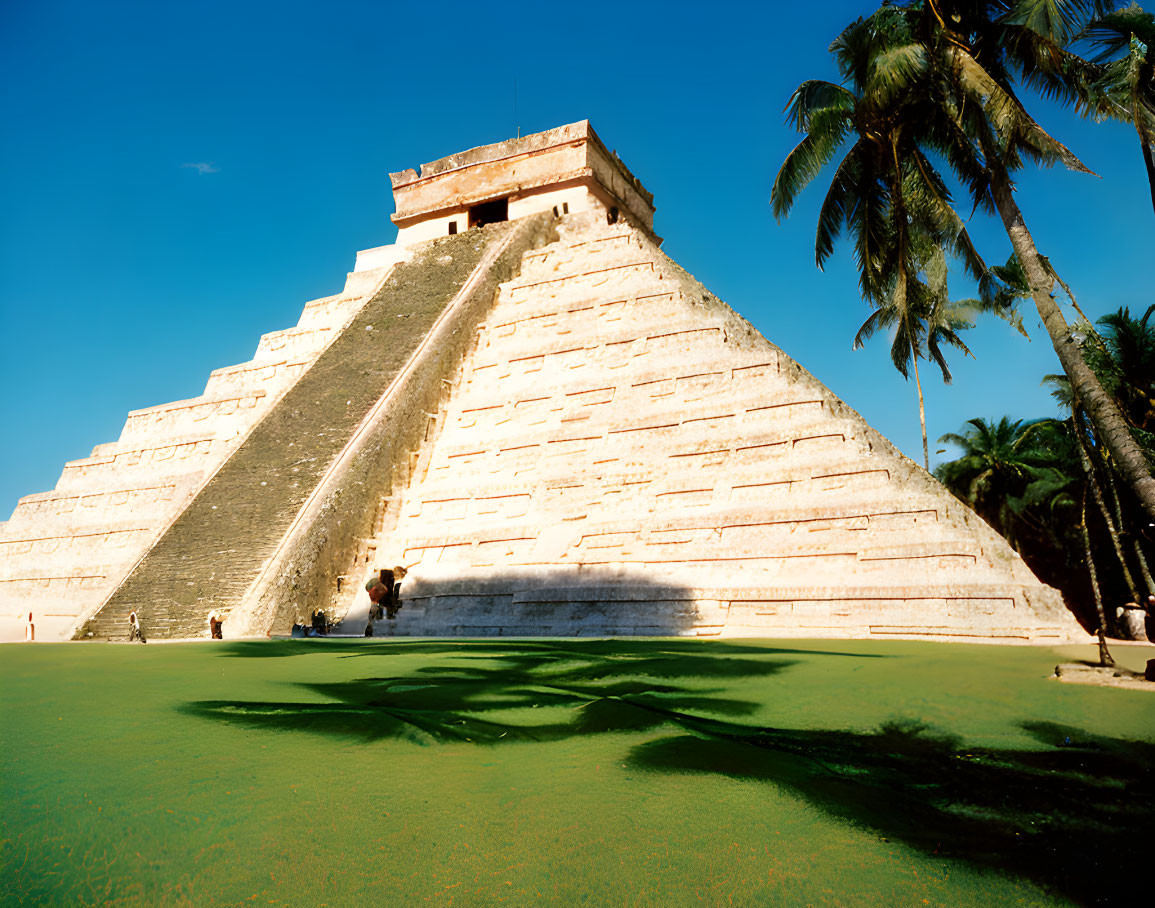 Ancient Mayan pyramid of Kukulkan at Chichen Itza with blue sky