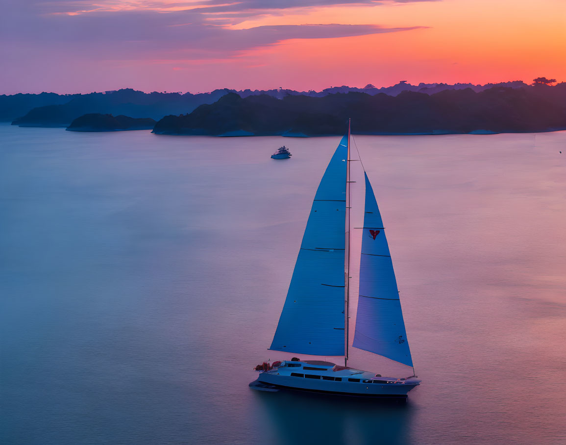 White Sail Sailboat on Calm Waters at Sunset with Silhouetted Islands