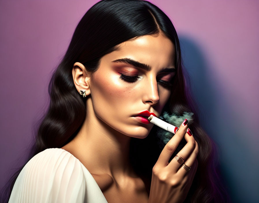 Woman with striking makeup and elegant jewelry holding a lit cigarette on purple backdrop