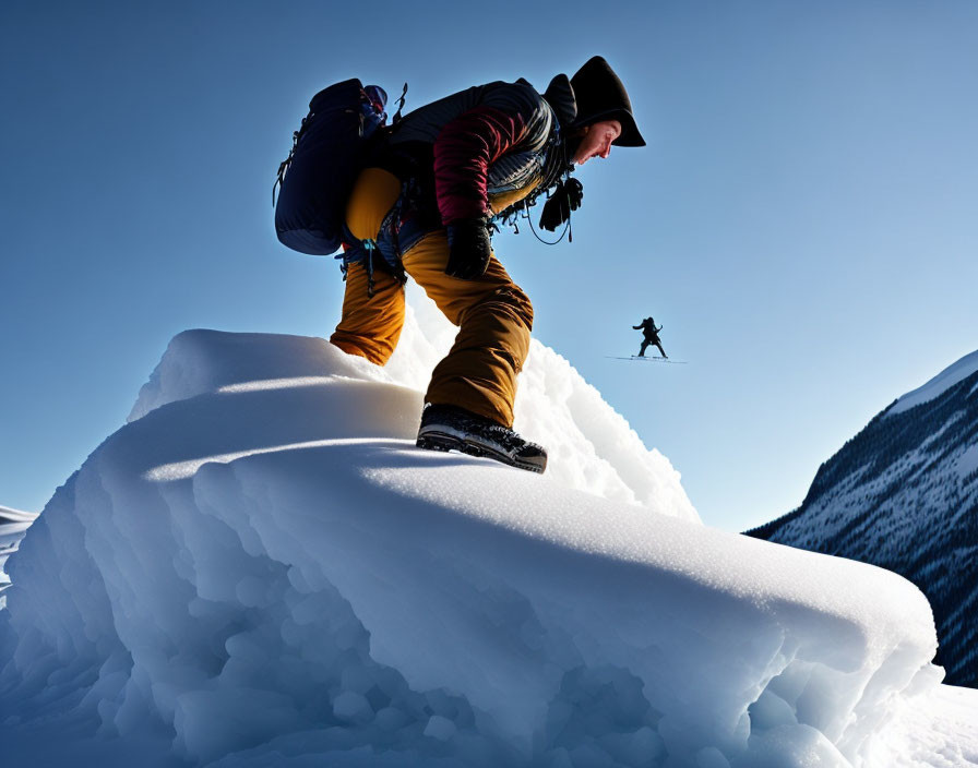 Snowy ridge ascent with climbers against clear blue sky