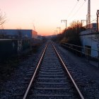 Child on Railway Tracks with Sunset, Moon, Birds, and Desert Landscape