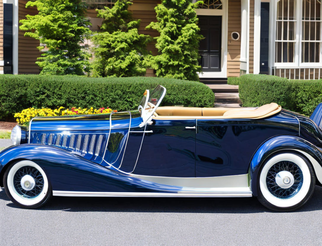 Vintage Blue Car with White Wall Tires Parked in Front of House with Porch and Blooming