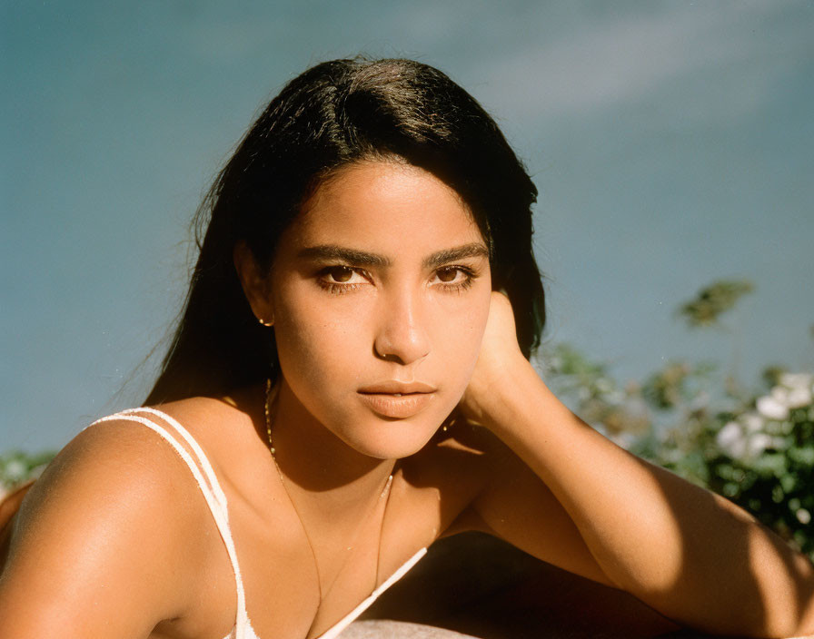 Dark-Haired Woman Contemplating Against Blue Sky