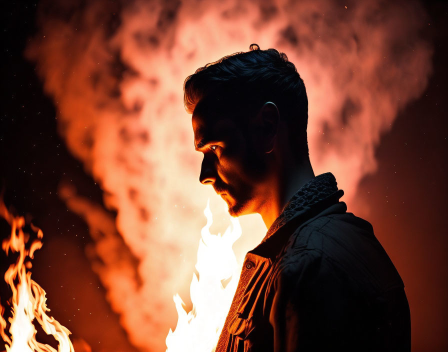 Intense profile of a man against flames and embers