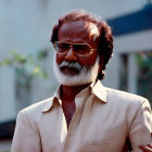 Bearded man with sunglasses holding a cup of tea in warm sunlight