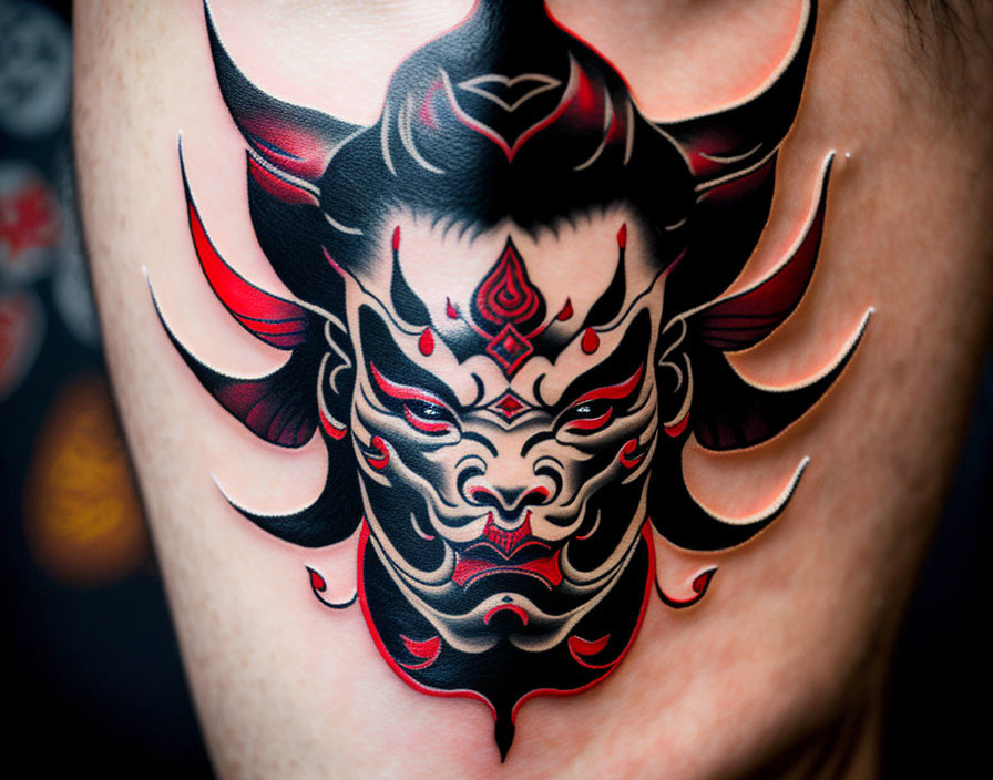 Detailed Red and Black Oni Tattoo on Arm