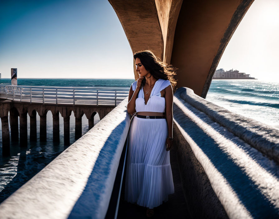 Woman in White Dress Standing Under Arched Beach Structure