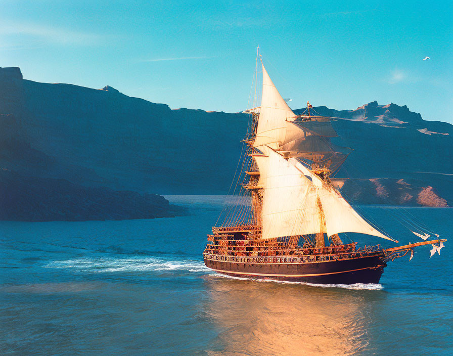 Classic Tall Ship Sailing Near Rugged Coastline