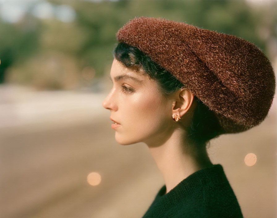 Profile View of Woman in Beret with Bokeh Highlights in Daylight