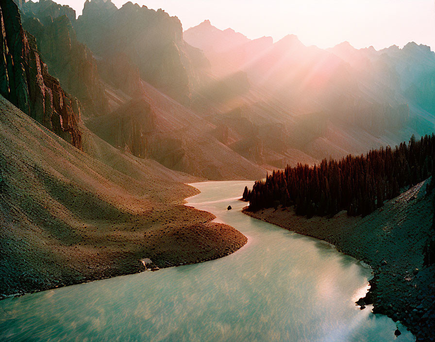 Sunbeams shining on mountain river at dawn or dusk