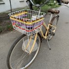 Vintage-style bicycle with golden details parked on cobblestone path.