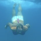 Mermaid with teal tail and blue fish in serene underwater scene