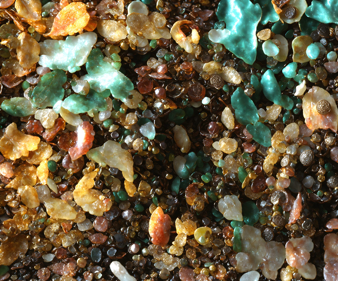 Vibrant Close-Up of Colorful Sand Grains in Green, Brown, and Translucent Cr