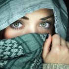 Woman with Blue Eyes Wearing Teal Scarf Holding Pencil