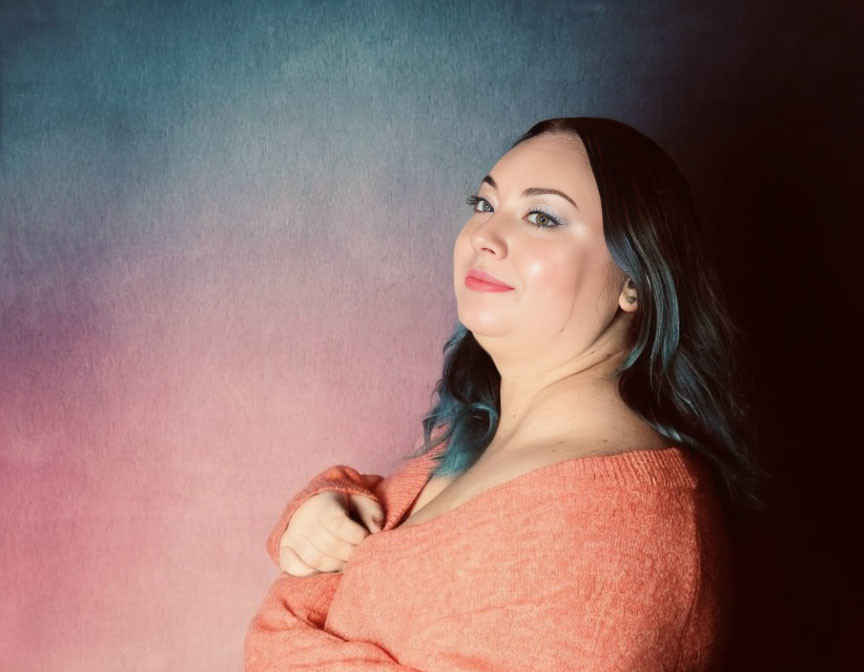 Blue-haired woman in peach top against mottled background