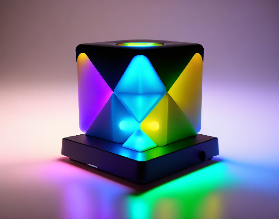 Multicolored geometric light sculpture on black base casting reflections