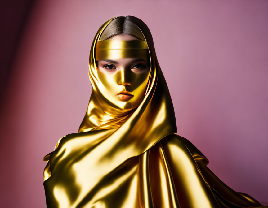 Golden Fabric Draped Figure Against Pink Background