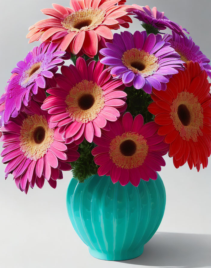 Multicolored Gerbera Daisies in Turquoise Vase on Neutral Background