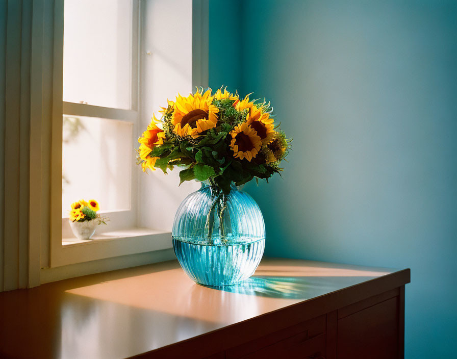 Sunflowers bouquet in blue vase on wooden surface with sunlight shadows