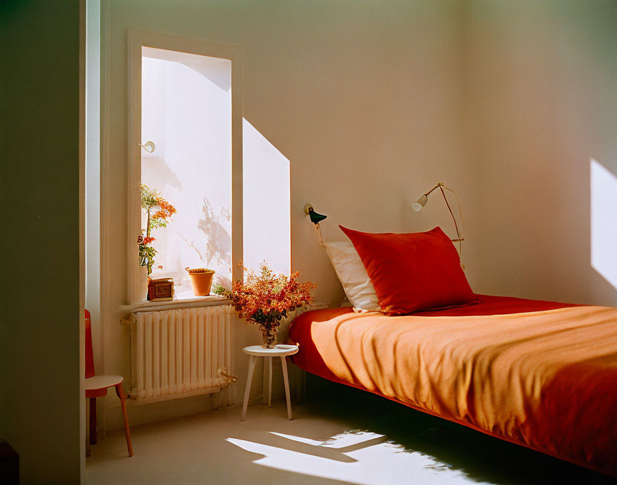 Warm Sunlight Illuminates Cozy Bedroom with Orange Bedspread