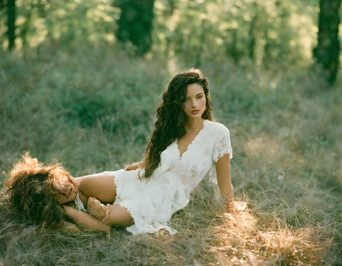 Curly-haired woman in white lace dress in sunlit forest clearing