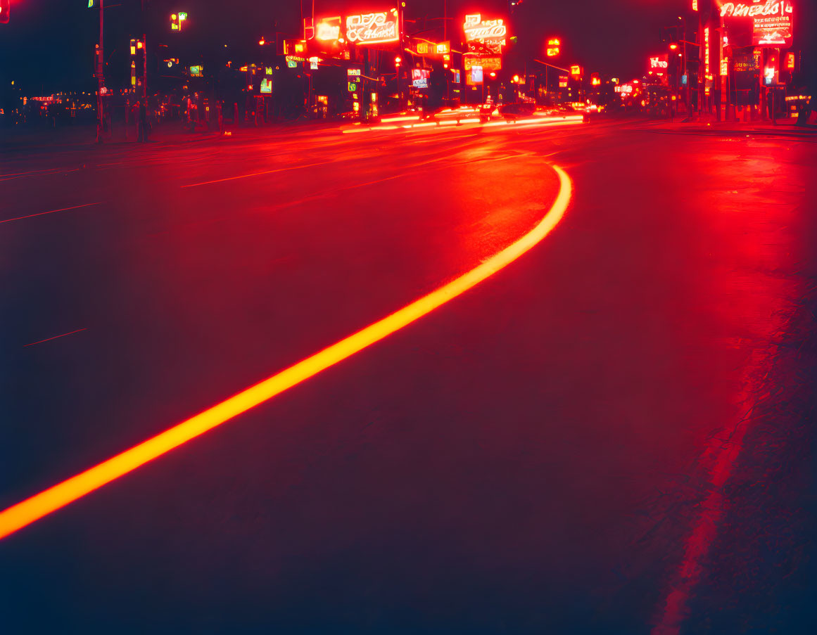 City street at night with neon lights and red taillight streaks captured in long exposure.