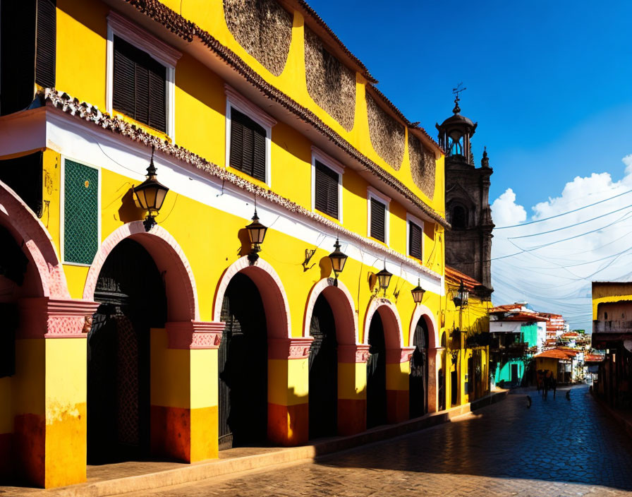 Vibrant colonial buildings with arches under blue sky in town street