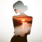 Person's Silhouette with Sunset Landscape and Woman Inside